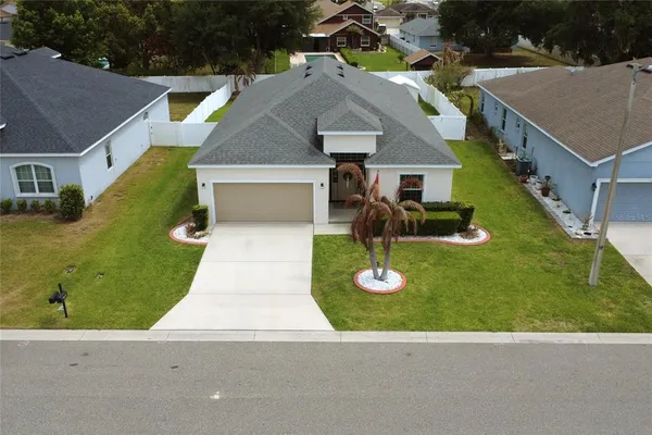 an aerial view of house with yard swimming pool and outdoor seating
