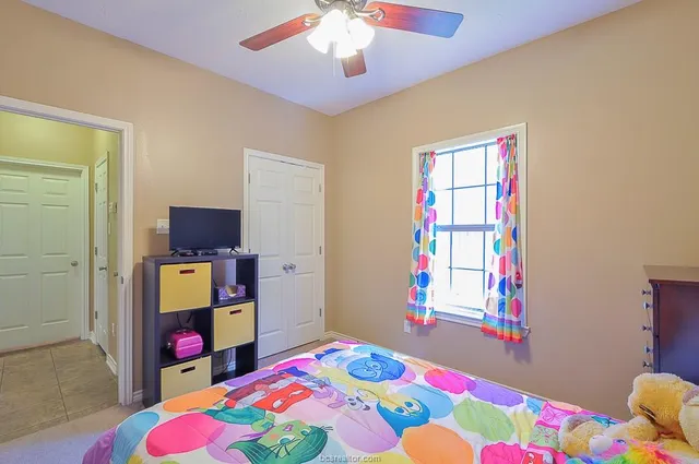 a bedroom that has a bed and a dresser in it