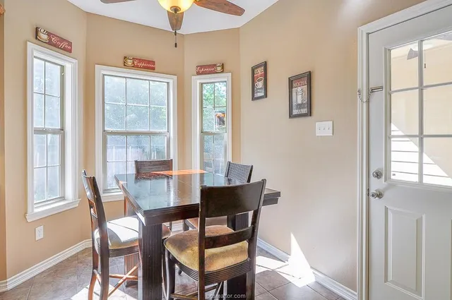 a dining room with furniture and window