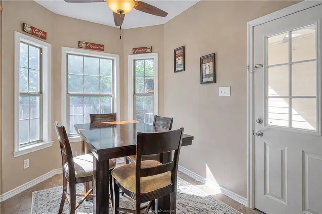 a dining room with furniture and window