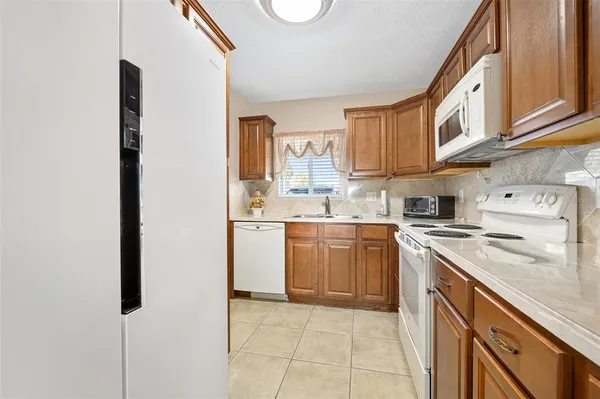 a kitchen with a sink window and cabinets