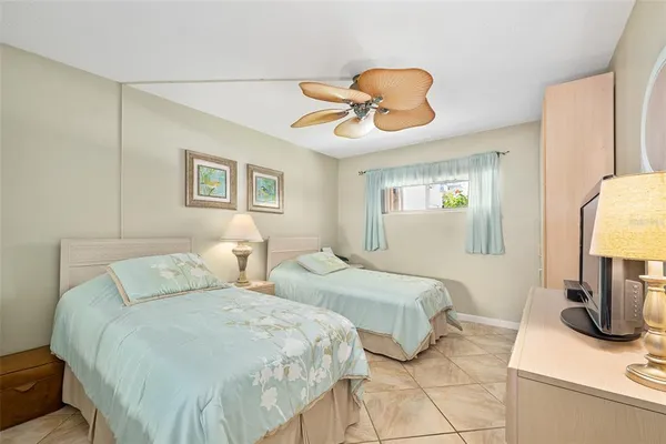 a bedroom with two beds and painting on the wall