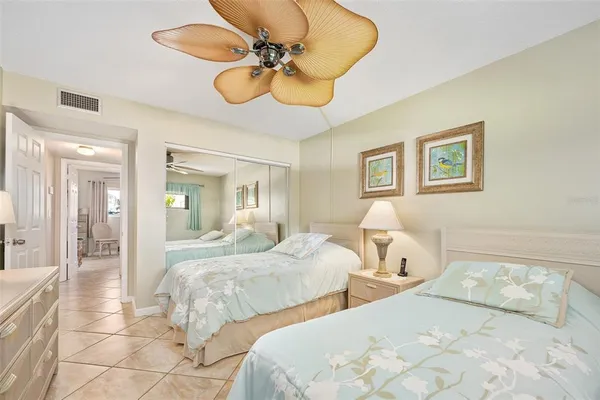 a bedroom with two beds and a chandelier