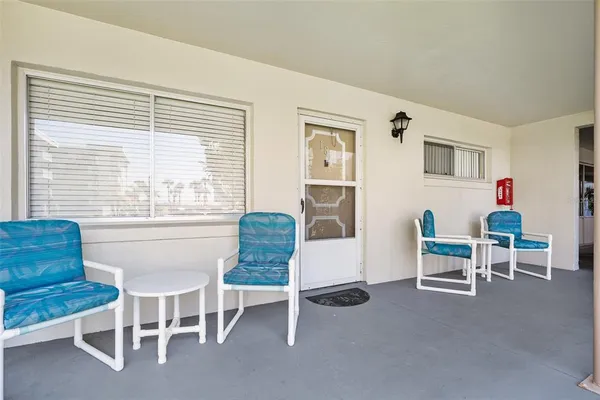 a living room with furniture a flat screen tv and a window
