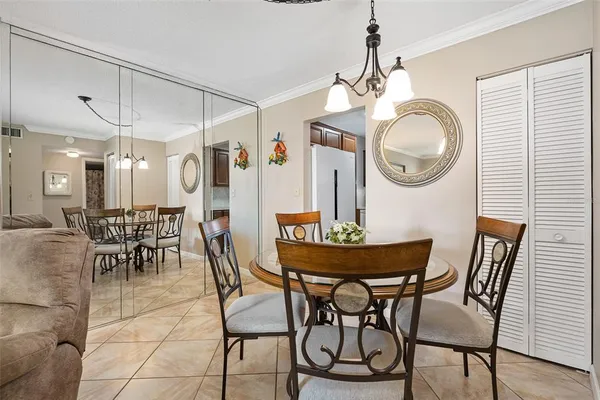 a view of a dining room and kitchen with furniture kitchen appliances and chandelier