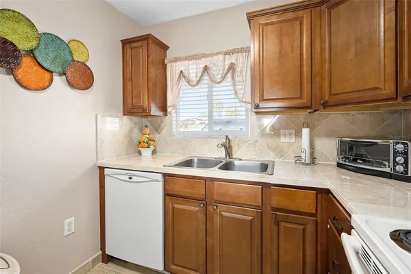 a kitchen with a sink a stove and cabinets