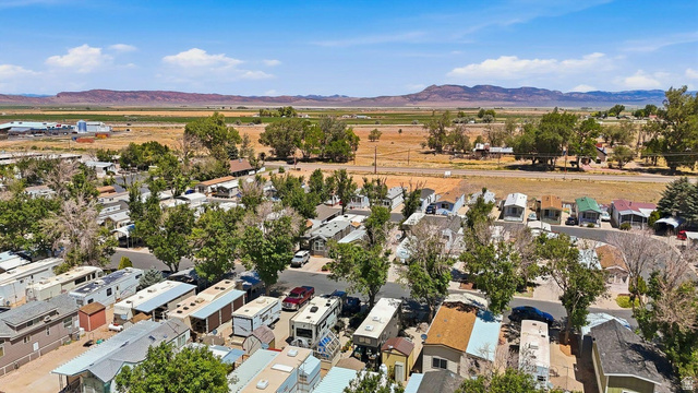416 Kari Parowan, UT 84761 - Photo 6 of 14 Rural landscape featuring established trees and distant mountain ranges under a clear sky