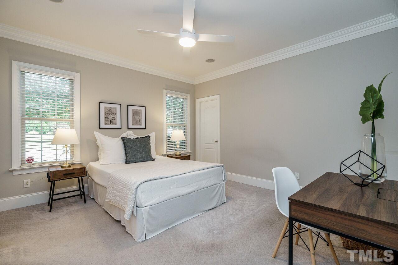 4813 Patton Ridge Court Raleigh, NC 27612 - Photo 18 of 30 a bedroom with a bed and a table in it with window