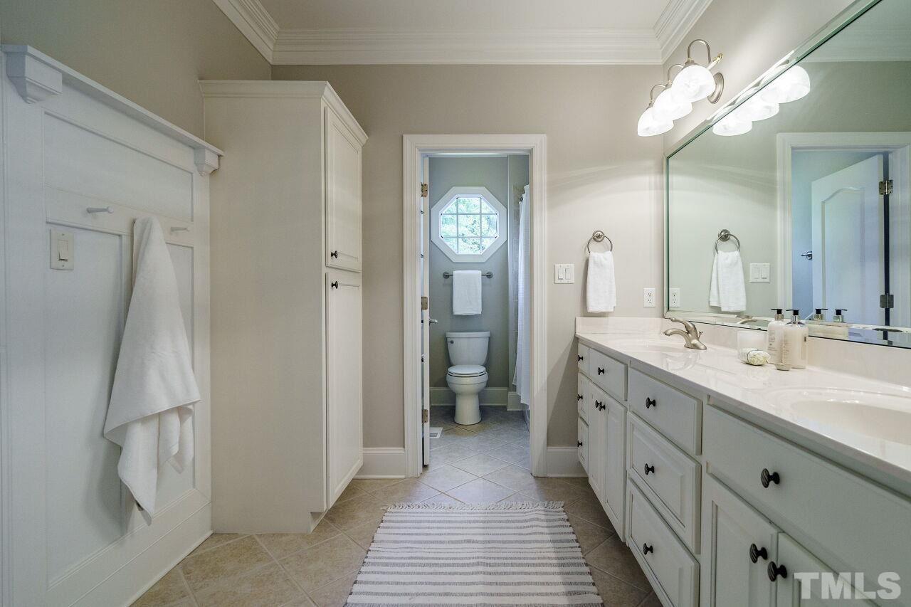 4813 Patton Ridge Court Raleigh, NC 27612 - Photo 19 of 30 a spacious bathroom with a double vanity sink and a mirror