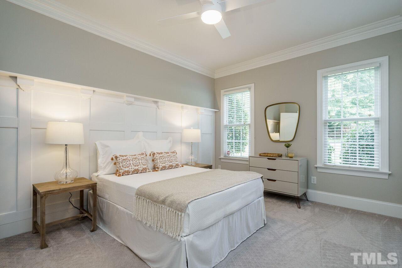 4813 Patton Ridge Court Raleigh, NC 27612 - Photo 20 of 30 a bedroom with a bed a mirror and a window