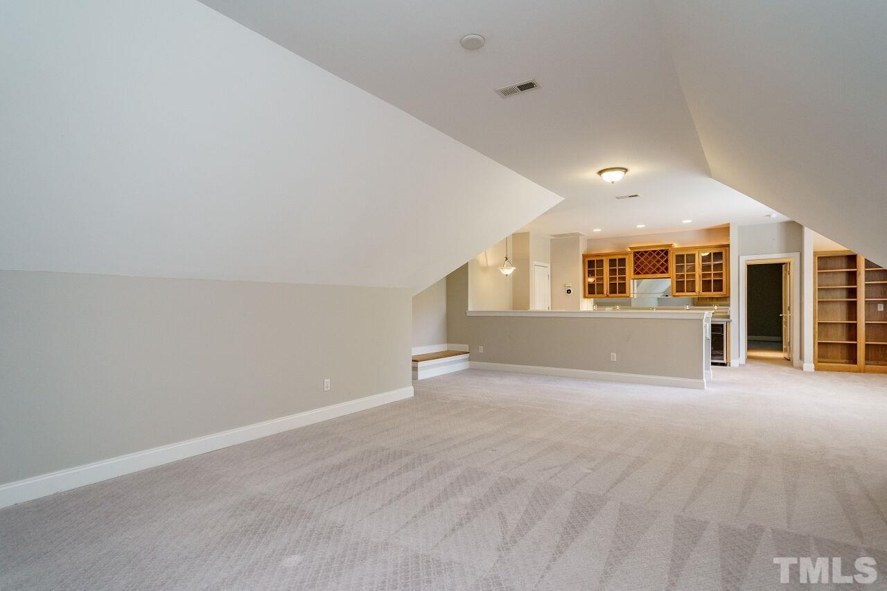 4813 Patton Ridge Court Raleigh, NC 27612 - Photo 23 of 30 a view of a big room with wooden cabinet and windows