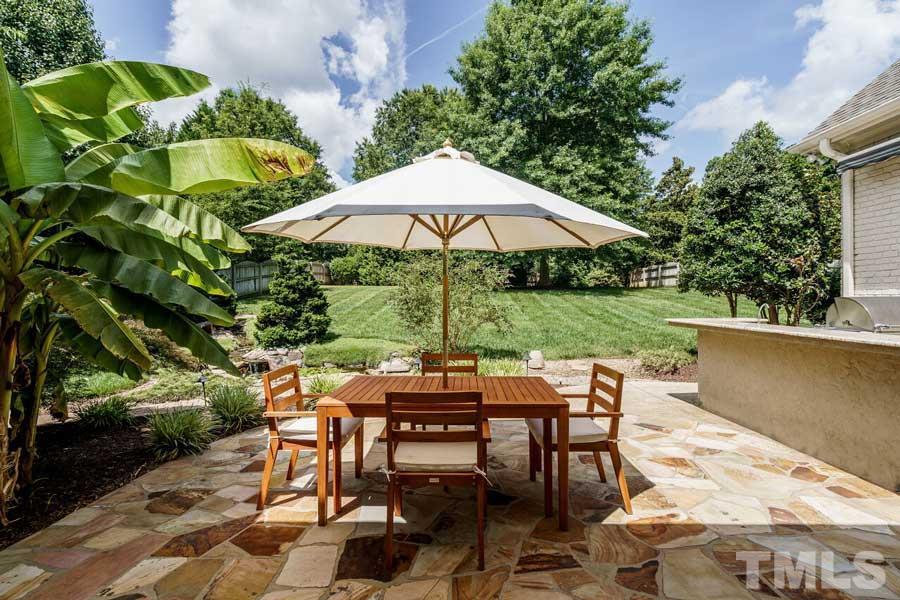 4813 Patton Ridge Court Raleigh, NC 27612 - Photo 27 of 30 a view of backyard with seating space and trees
