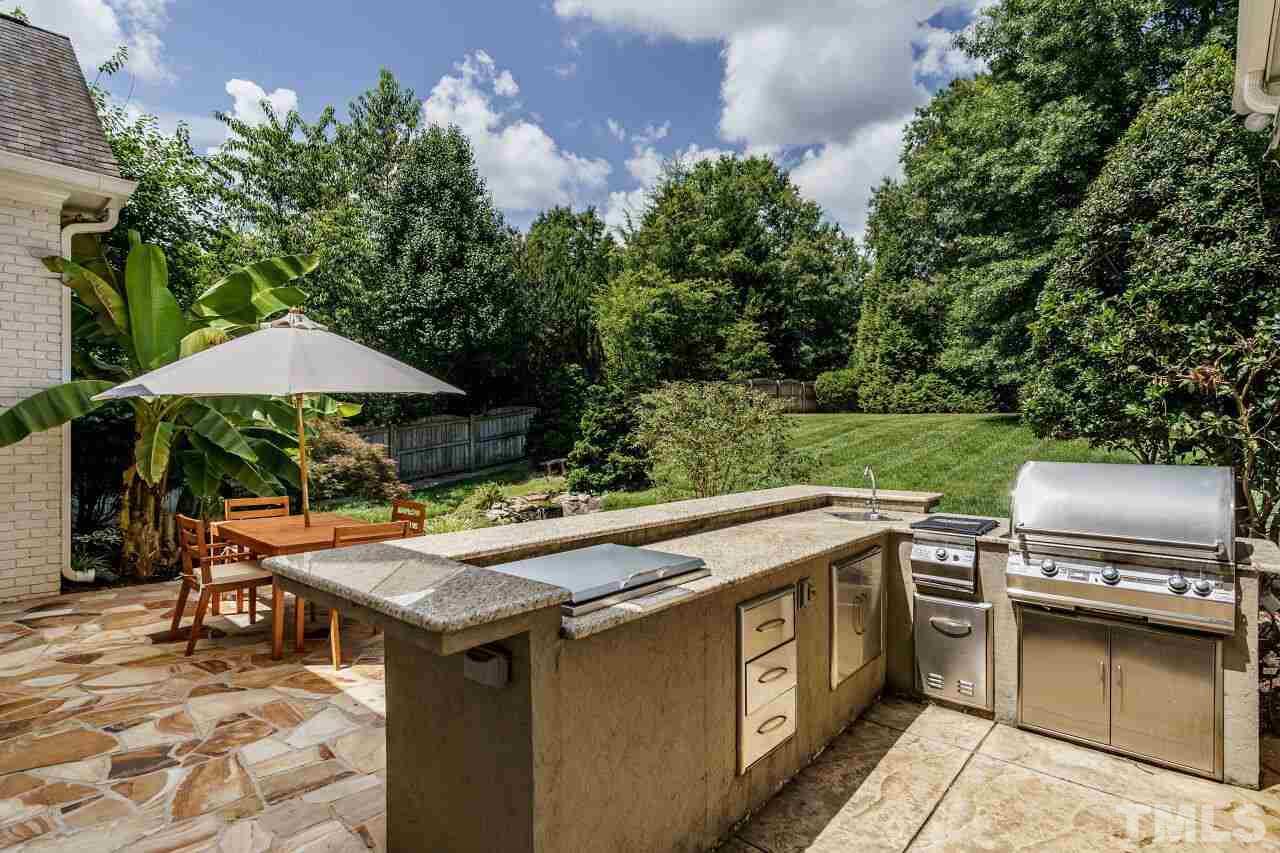 4813 Patton Ridge Court Raleigh, NC 27612 - Photo 28 of 30 an outdoor space with furniture and umbrella