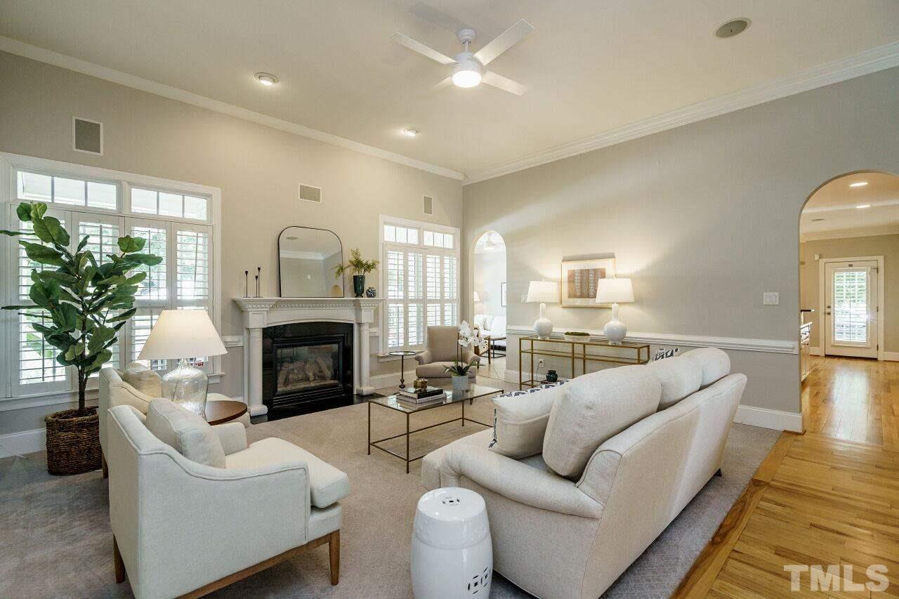 4813 Patton Ridge Court Raleigh, NC 27612 - Photo 7 of 30 a living room with furniture a fireplace and a potted plant