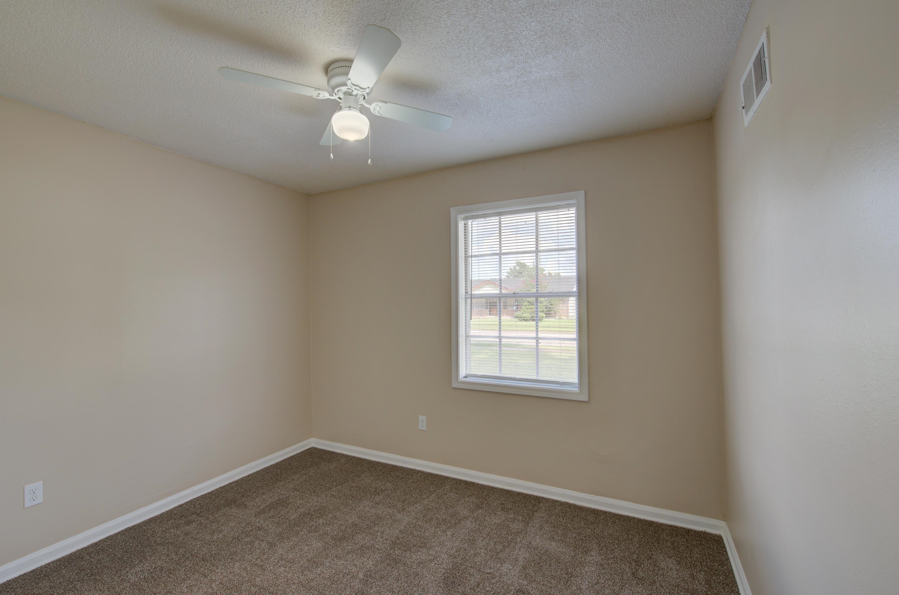 5193 Fairley Road Memphis, TN 38109 - Photo 12 of 17 an empty room with a window and a ceiling fan