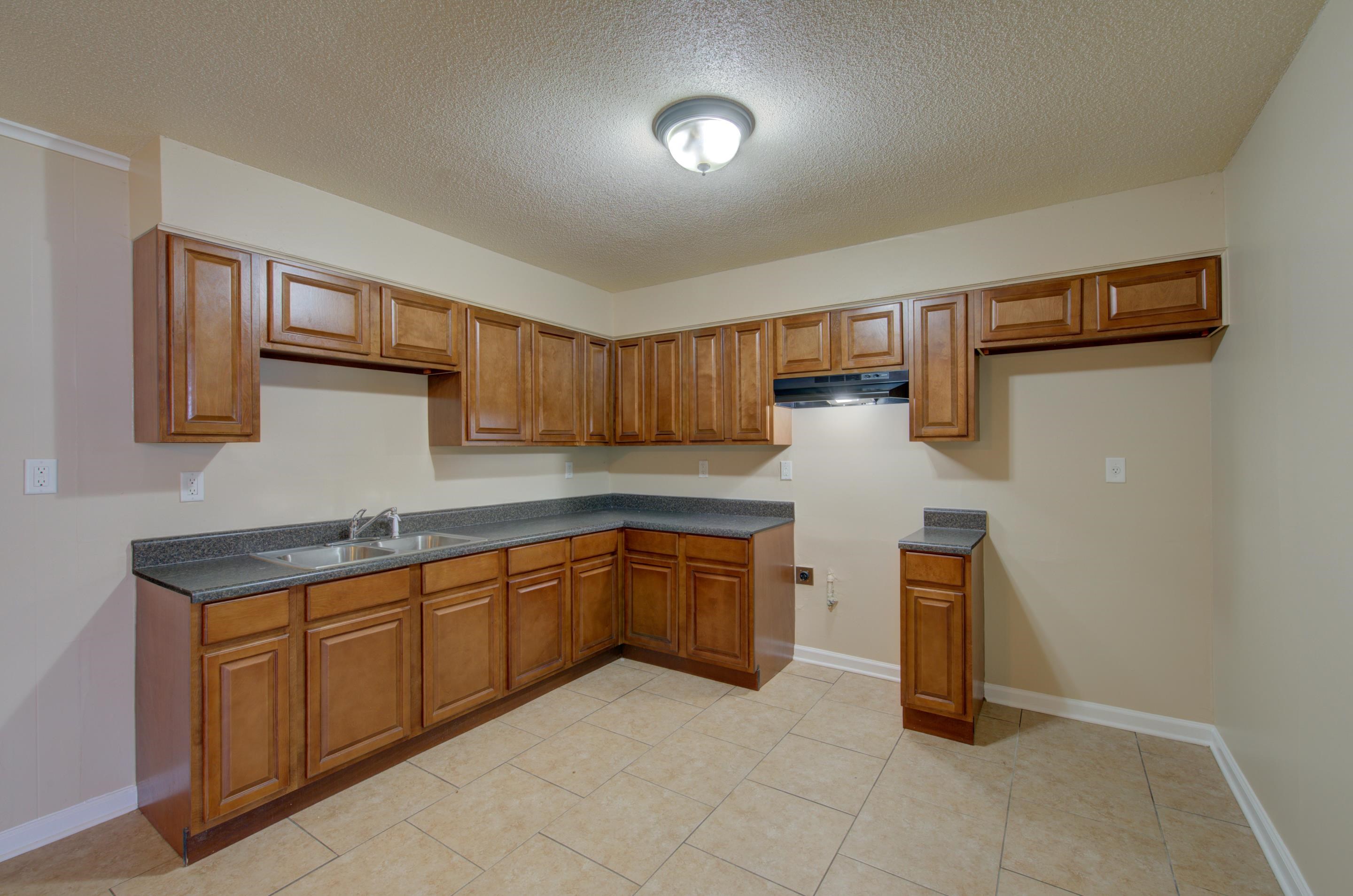 5193 Fairley Road Memphis, TN 38109 - Photo 4 of 17 a kitchen with stainless steel appliances granite countertop a sink and cabinets