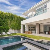 a view of a house with swimming pool and sitting area