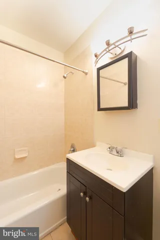 a bathroom with a sink vanity and a mirror