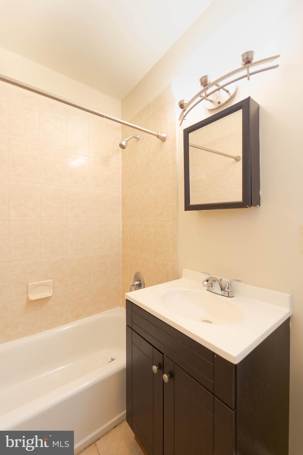 444 Rhode Island Avenue Northwest, Unit 302 Washington, DC 20001 - Photo 11 of 13 a bathroom with a sink vanity and a mirror