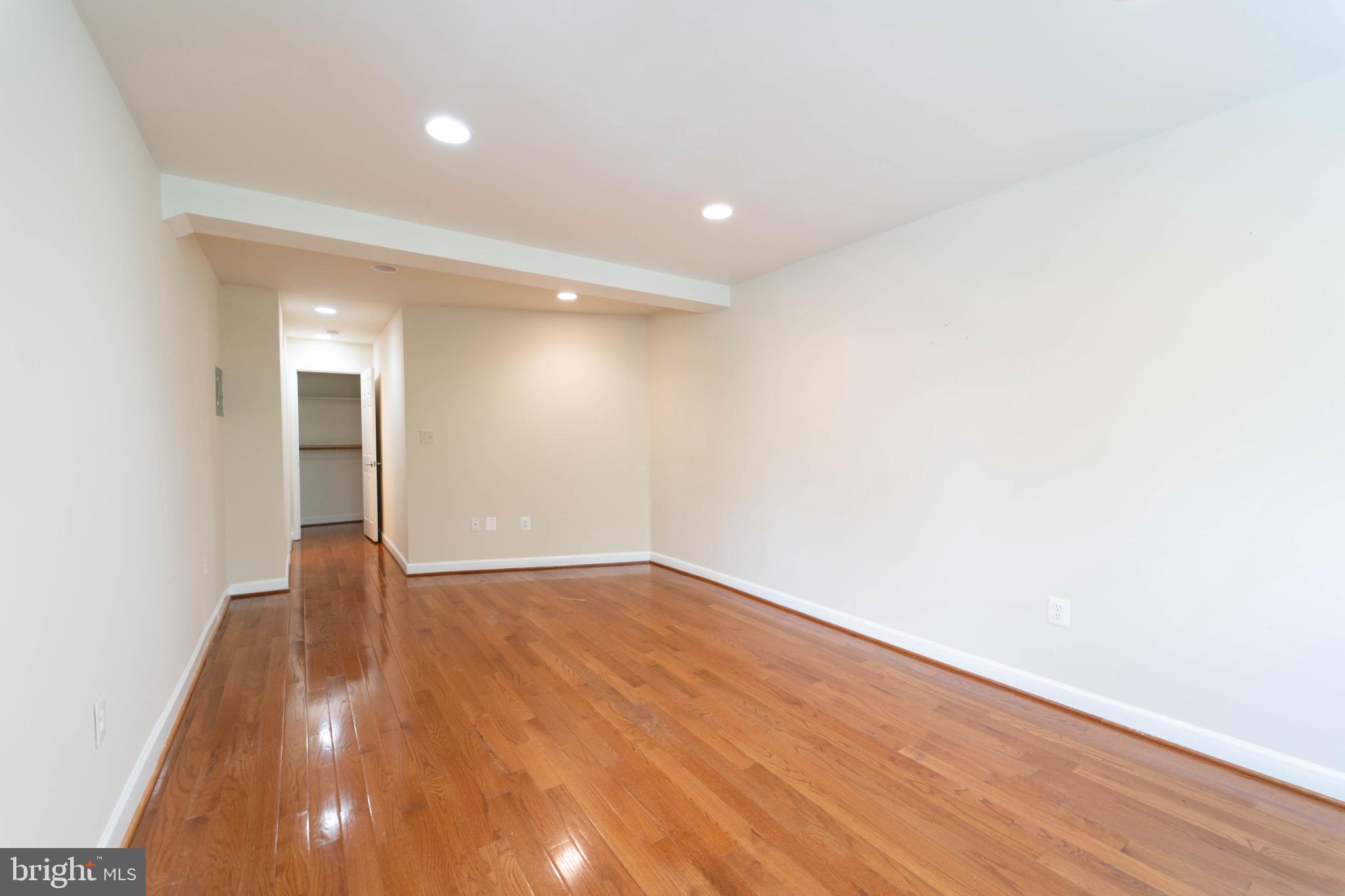 444 Rhode Island Avenue Northwest, Unit 302 Washington, DC 20001 - Photo 7 of 13 a view of an empty room with wooden floor and a window