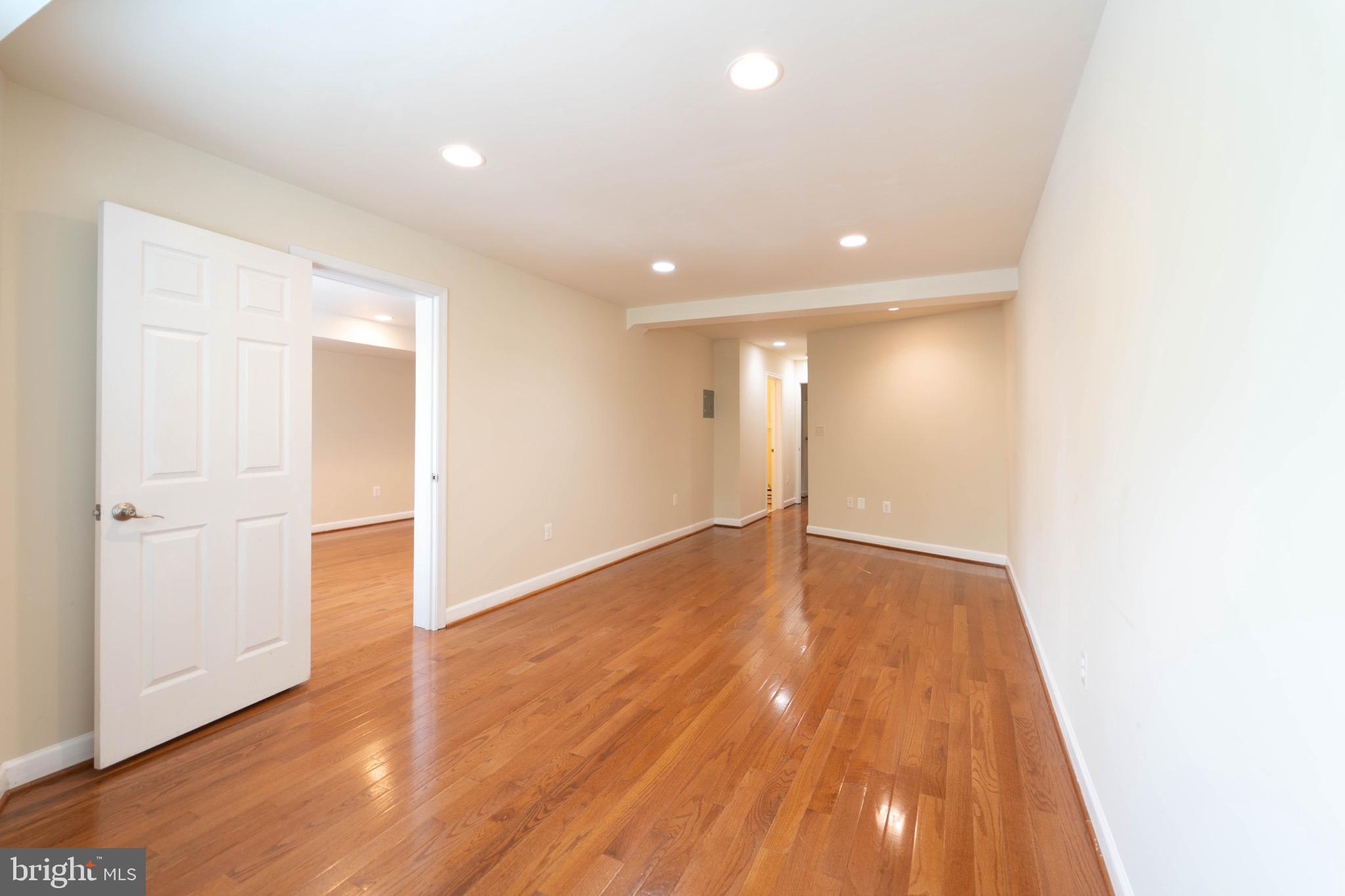 444 Rhode Island Avenue Northwest, Unit 302 Washington, DC 20001 - Photo 8 of 13 a view of an empty room with wooden floor