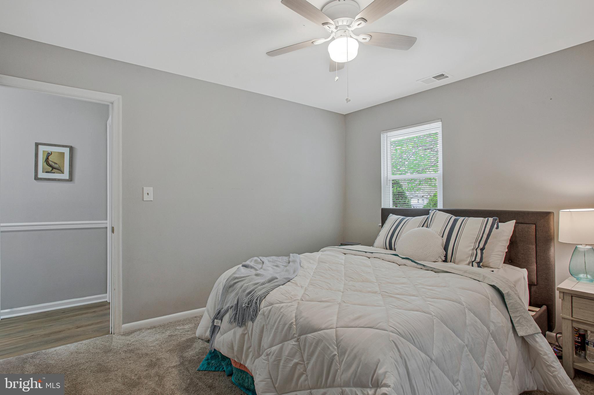 114 River Road Edgewater, MD 21037 - Photo 20 of 30 a bed sitting in a bedroom next to a window