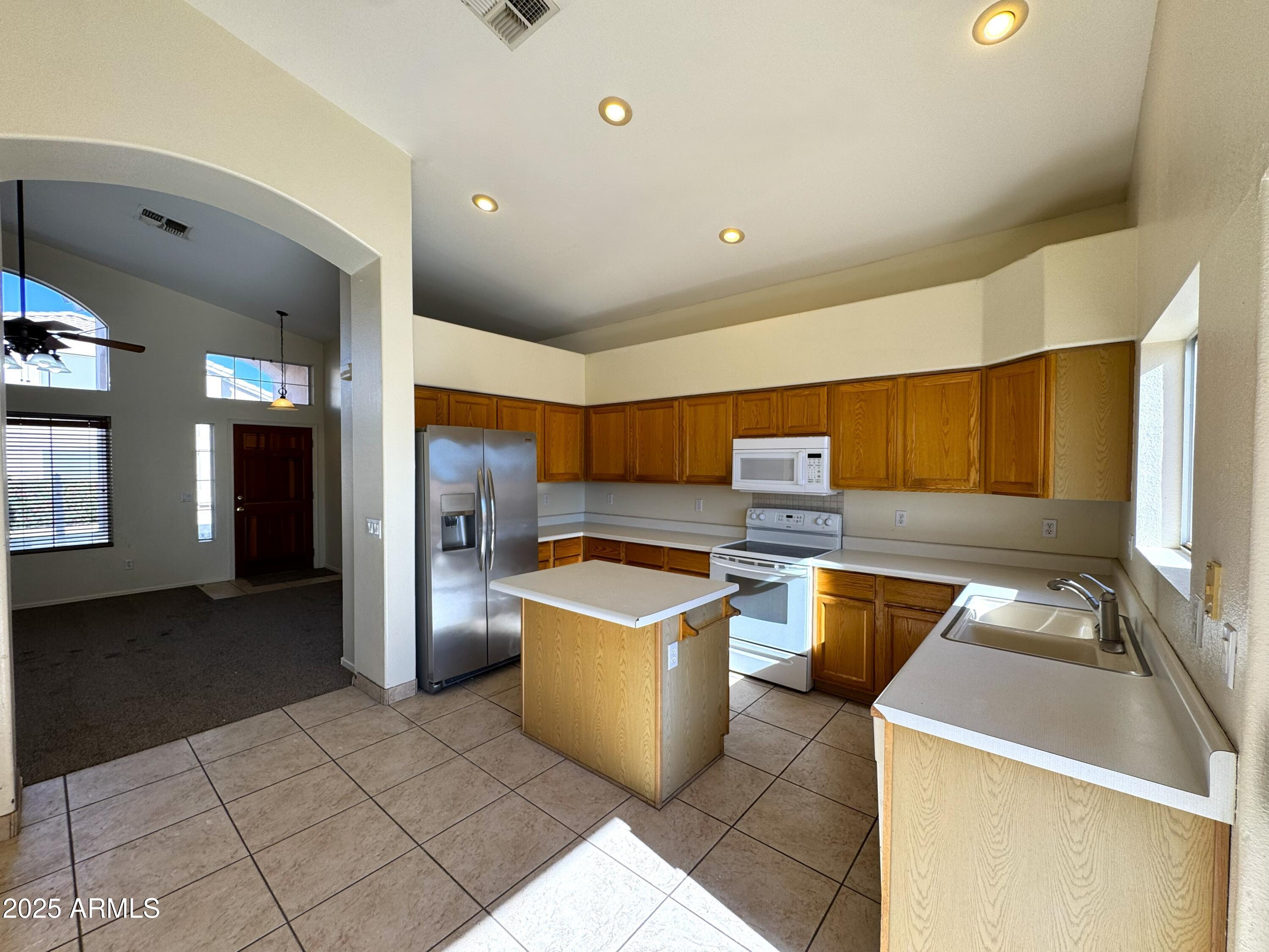 4906 East Brown Road, Unit 38 Mesa, AZ 85205 - Photo 4 of 14 a kitchen with appliances cabinets and furniture