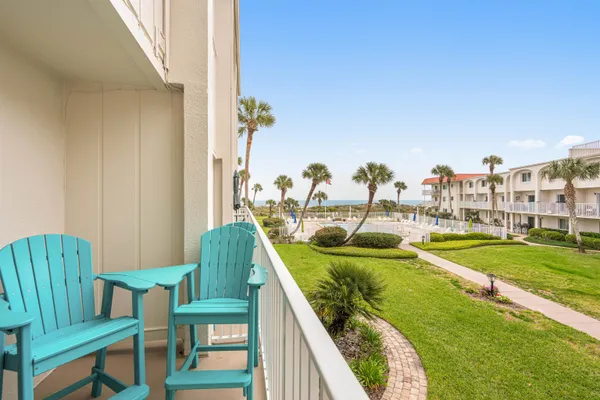 a balcony with chairs and table