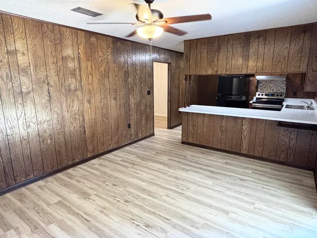 a kitchen with stainless steel appliances granite countertop wooden cabinets and sink