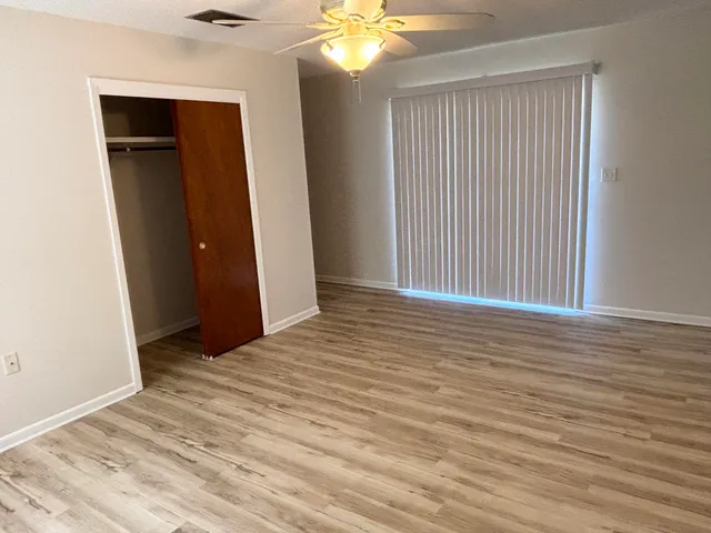 wooden floor in an empty room with a window