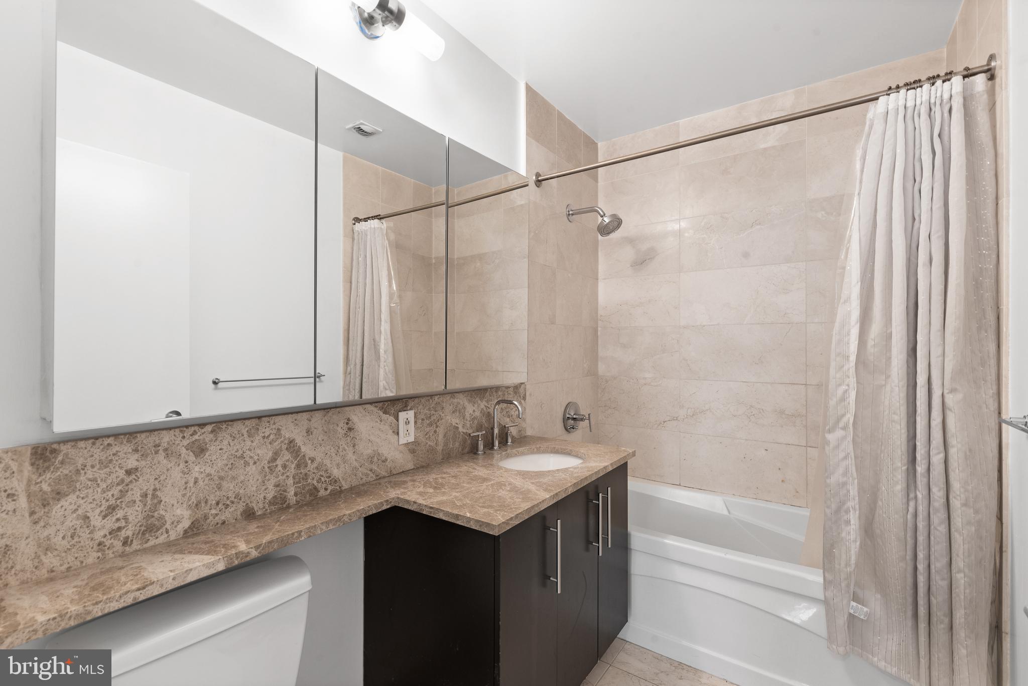 1425 Locust Street, Unit 9E Philadelphia, PA 19102 - Photo 14 of 15 a bathroom with a sink and a mirror