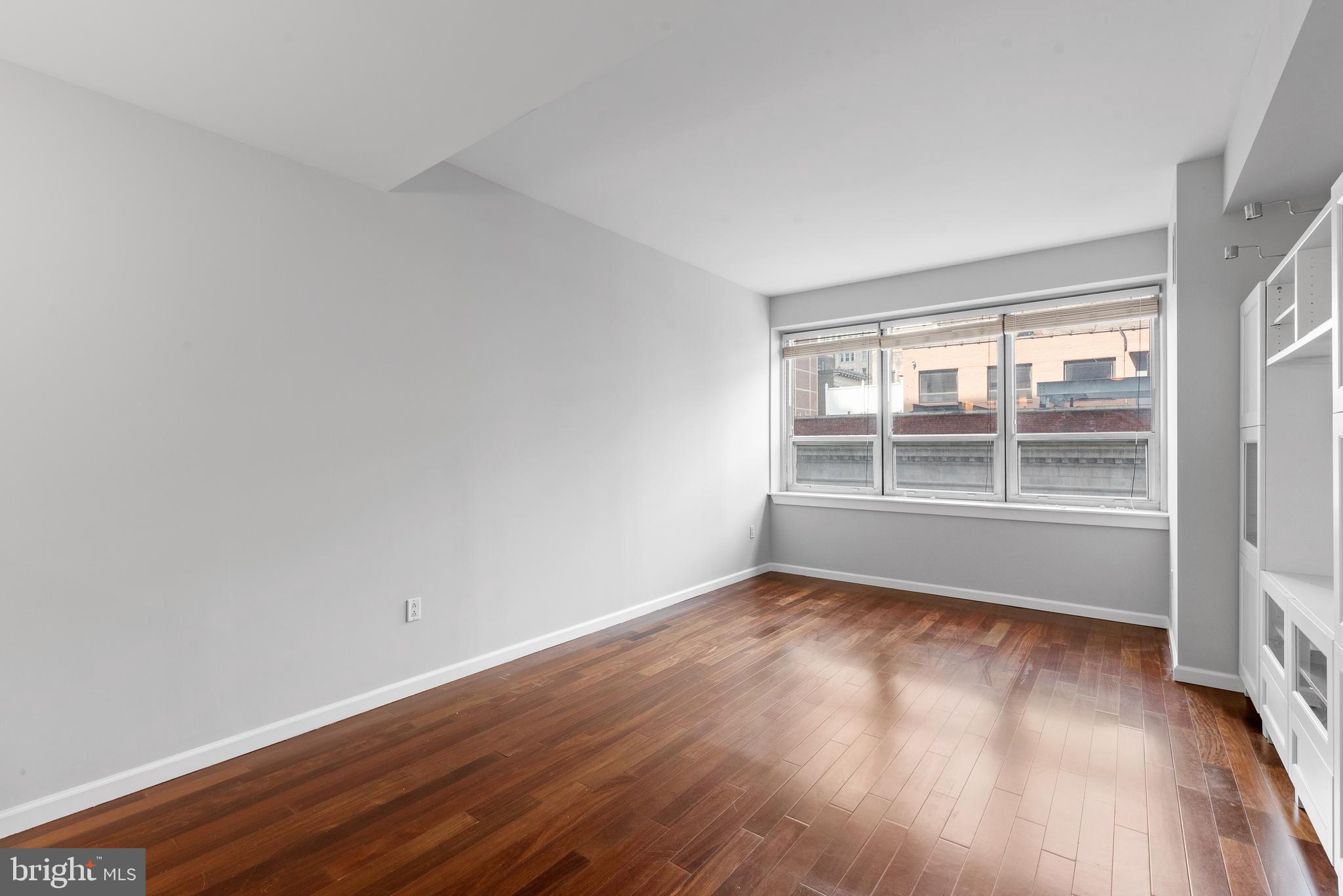 1425 Locust Street, Unit 9E Philadelphia, PA 19102 - Photo 4 of 15 wooden floor in an empty room with a window