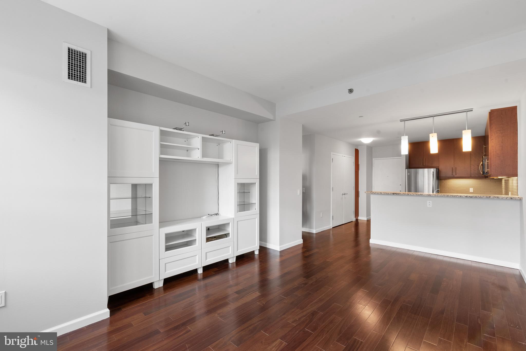 1425 Locust Street, Unit 9E Philadelphia, PA 19102 - Photo 5 of 15 a view of a kitchen with wooden floor and a window