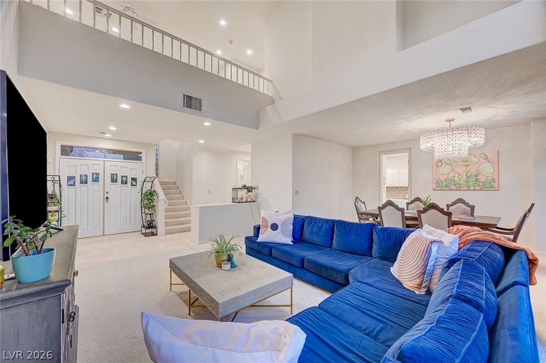 7995 Rio Rico Drive Las Vegas, NV 89113 - Photo 12 of 92 An inviting open-concept living area with a dramatic two-story ceiling and a grand entryway.