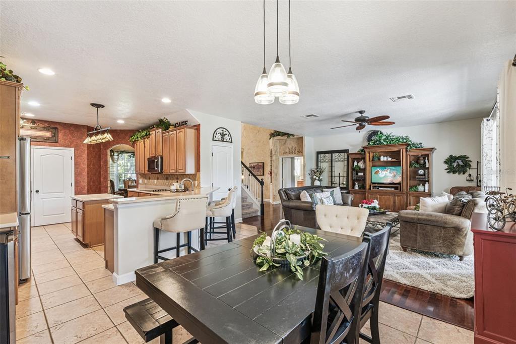 3304 Beazer Drive Ocoee, FL 34761 - Photo 14 of 53 a view of a dining room and livingroom with furniture wooden floor a chandelier