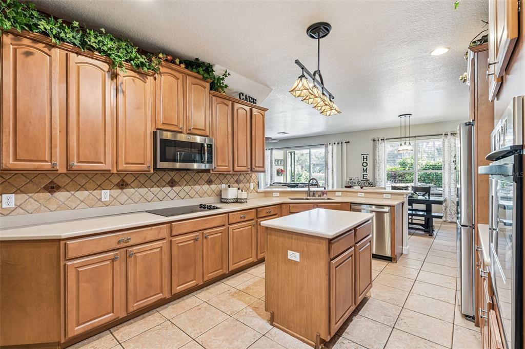 3304 Beazer Drive Ocoee, FL 34761 - Photo 19 of 53 a kitchen with granite countertop a sink stove and cabinets