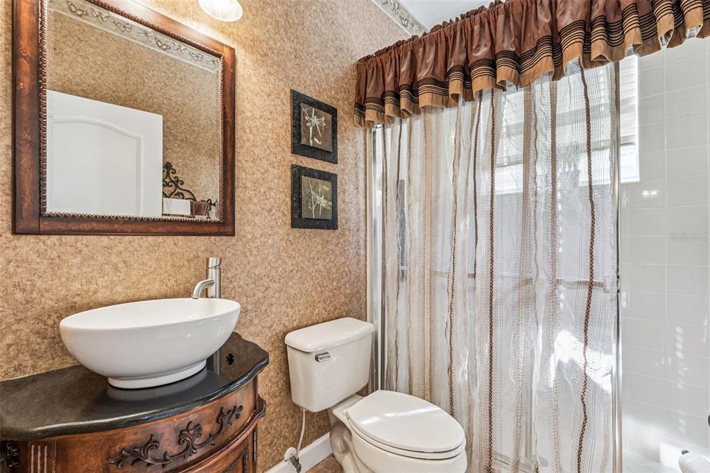 3304 Beazer Drive Ocoee, FL 34761 - Photo 25 of 53 a bathroom with a toilet a sink and a mirror