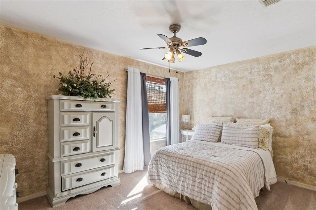 3304 Beazer Drive Ocoee, FL 34761 - Photo 33 of 53 a bedroom with a bed and a chandelier