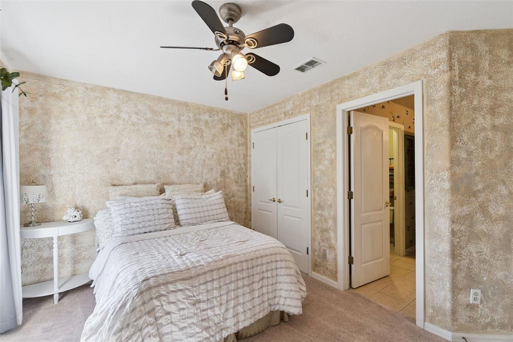 3304 Beazer Drive Ocoee, FL 34761 - Photo 34 of 53 a bedroom with a bed and a chandelier