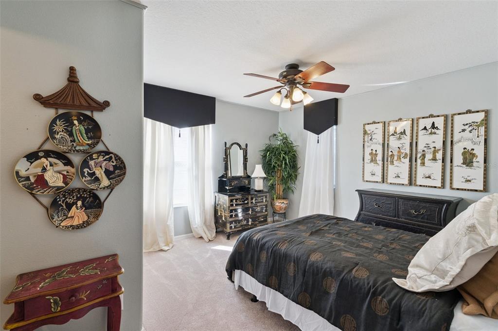 3304 Beazer Drive Ocoee, FL 34761 - Photo 37 of 53 a bedroom with a large bed and a chandelier
