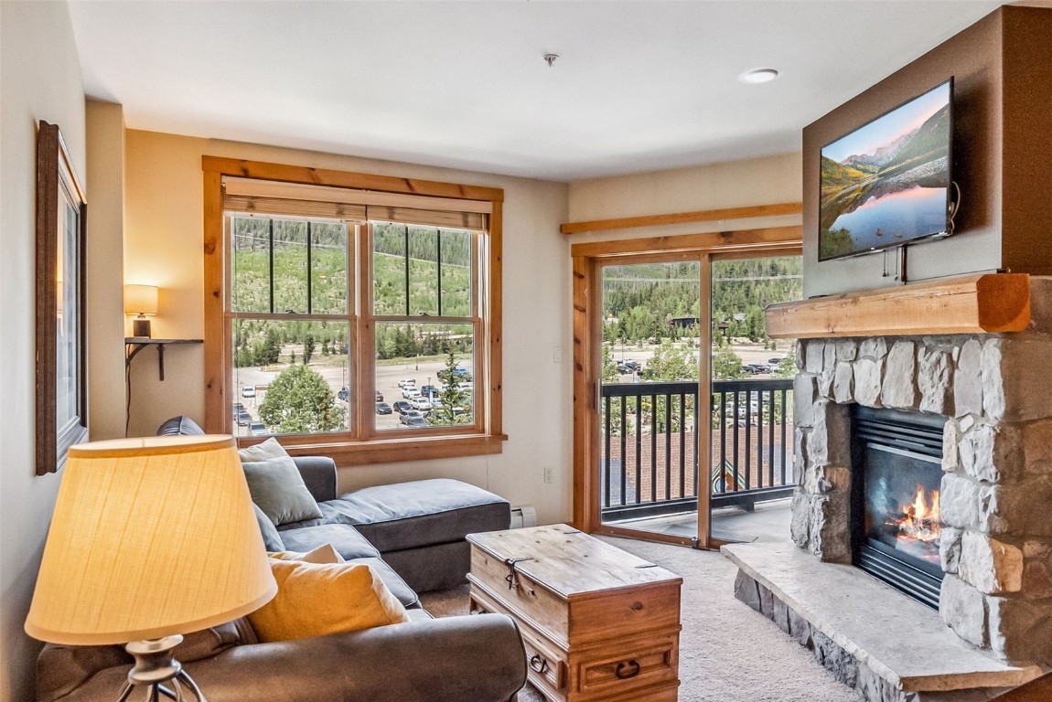 100 Dercum Square, Unit 8386 Keystone, CO 80435 - Photo 11 of 34 a living room with furniture a fireplace and a large window