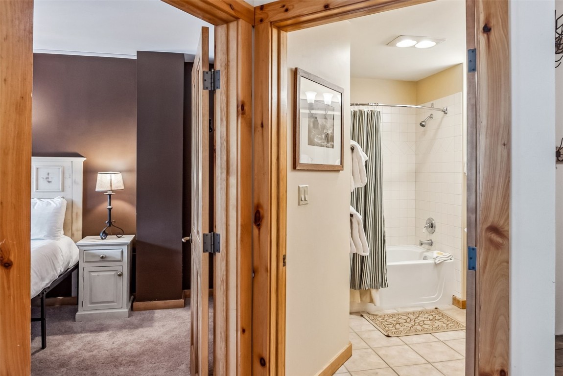 100 Dercum Square, Unit 8386 Keystone, CO 80435 - Photo 19 of 34 a bathroom with a glass shower door and a mirror