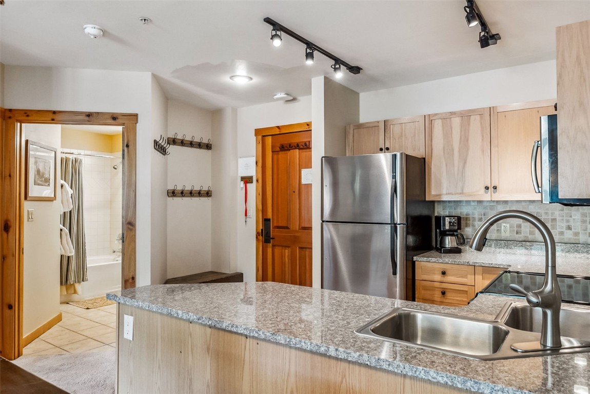 100 Dercum Square, Unit 8386 Keystone, CO 80435 - Photo 34 of 34 a kitchen with granite countertop a refrigerator and a sink