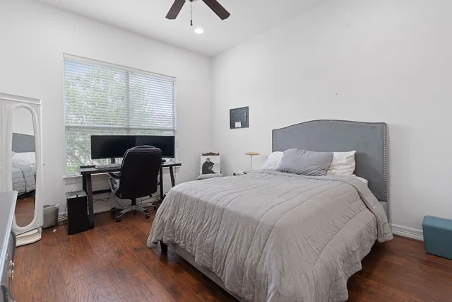 a bed room with a bed and a chair