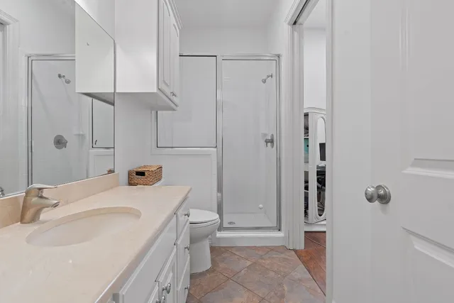 a bathroom with a sink toilet and shower
