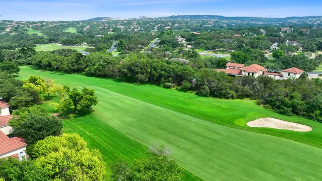 a view of a green field with lots of bushes