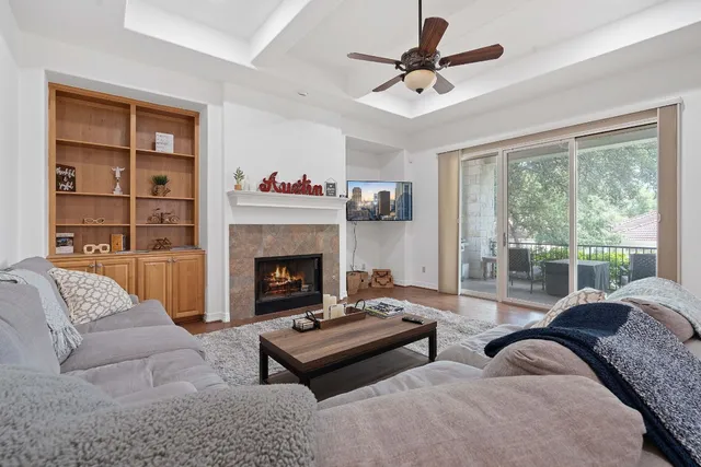 a living room with furniture fireplace and a large window
