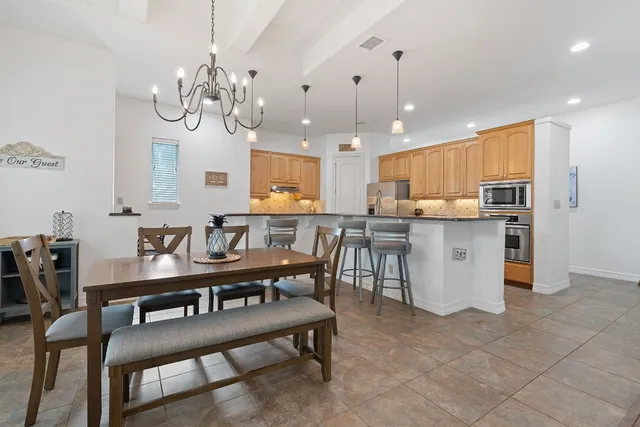 a large kitchen with a table and chairs