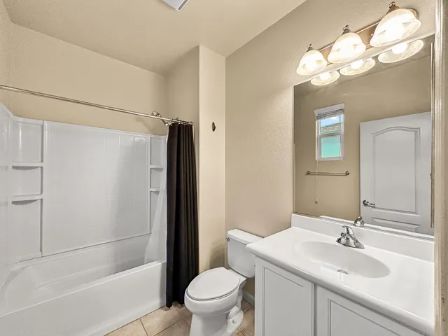 a bathroom with a sink toilet vanity and shower