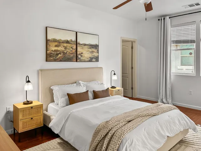 a bedroom with a bed and a chandelier